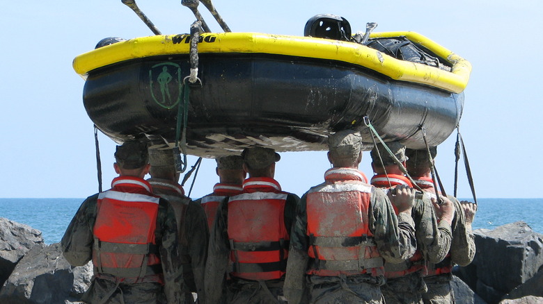 soldiers carry a boat