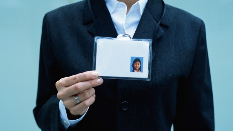 man holding blank ID card