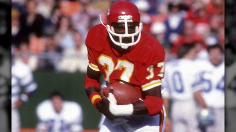 Joe Delaney running with football