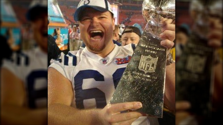 Matt Ulrich holding Super Bowl trophy