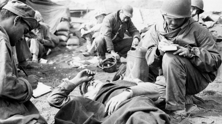 Medics writing during Iwo Jima