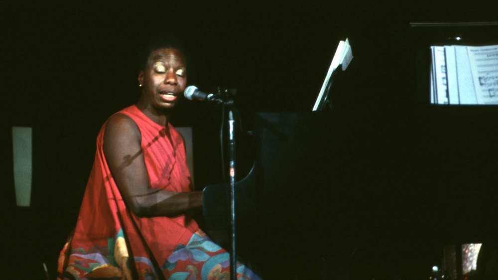 Nina Simone performing at the piano