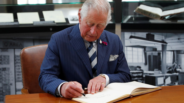 Prince Charles Signing a book