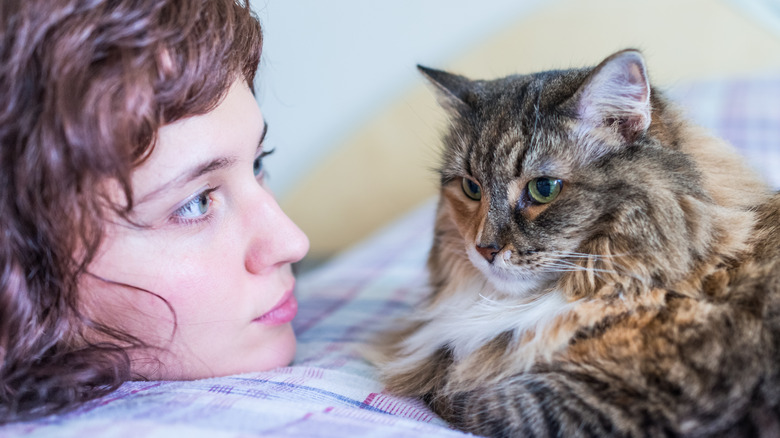 woman looking at her cat