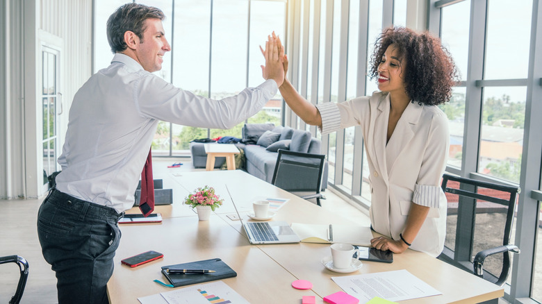 coworkers giving a high-five