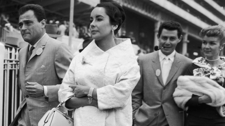 Elizabeth Taylor and Mike Todd walking in front of Debbie Reynolds and Eddie Fisher