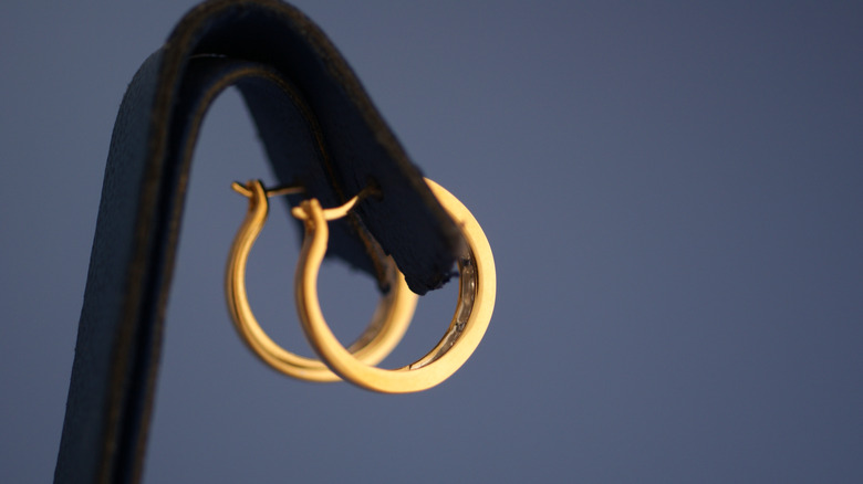 gold hoop earrings on stand