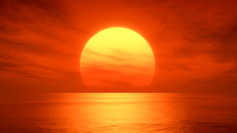 red sun over ocean
