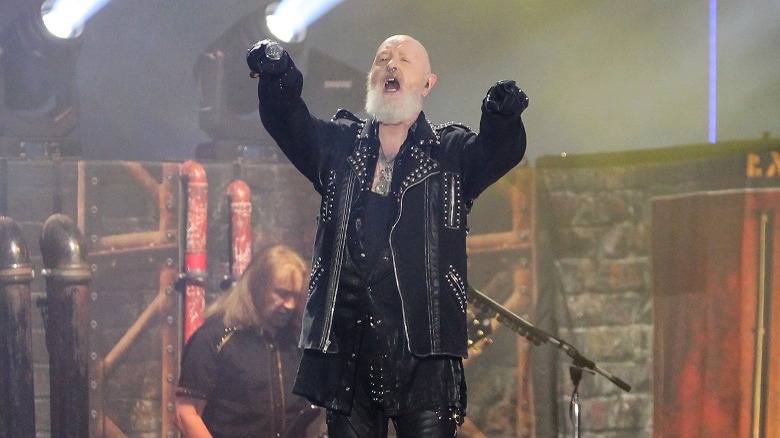 Halford white beard waving arms onstage