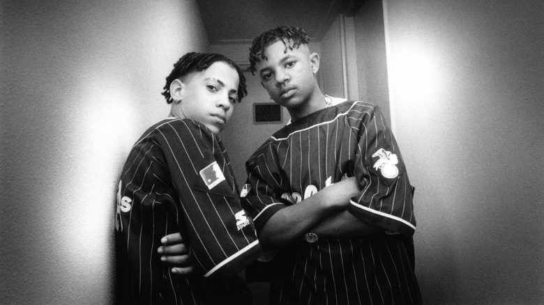 Kris Kross arms crosses narrow hallway