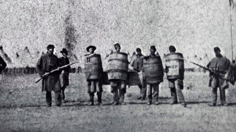 men wearing barrels