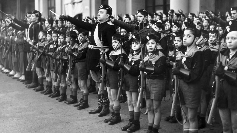 Balilla boys lined up with guns