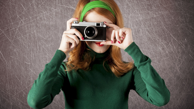 vintage 1960s woman taking photos