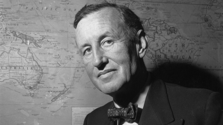 Ian Fleming in front of a map