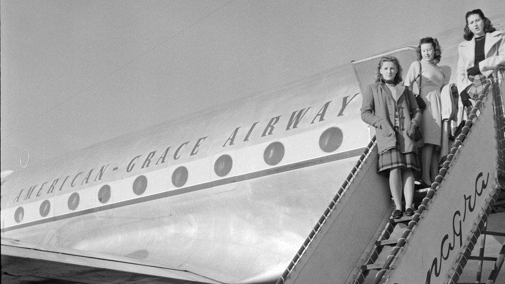 Pan Am stewardesses on stairs