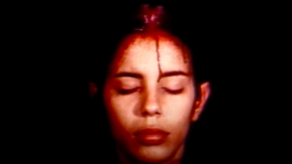 Ana Mendieta with blood on head