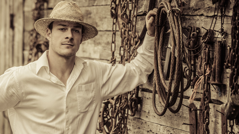 farmer with a wall of tools