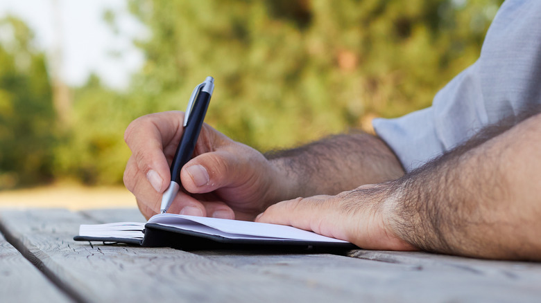 man writing a letter 