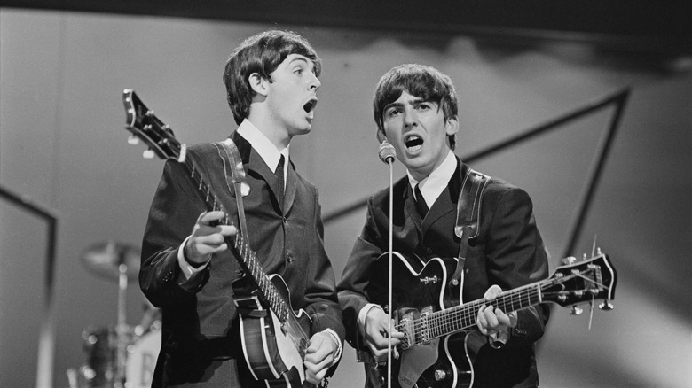 George Harrison and Paul McCartney performing