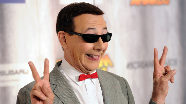 Paul Reubens as Pee-wee sunglasses hands raised