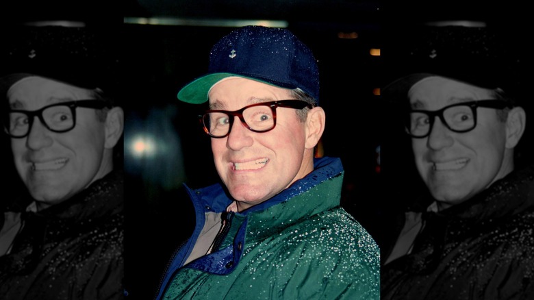 Phil Hartman glasses green jacket hat smiling