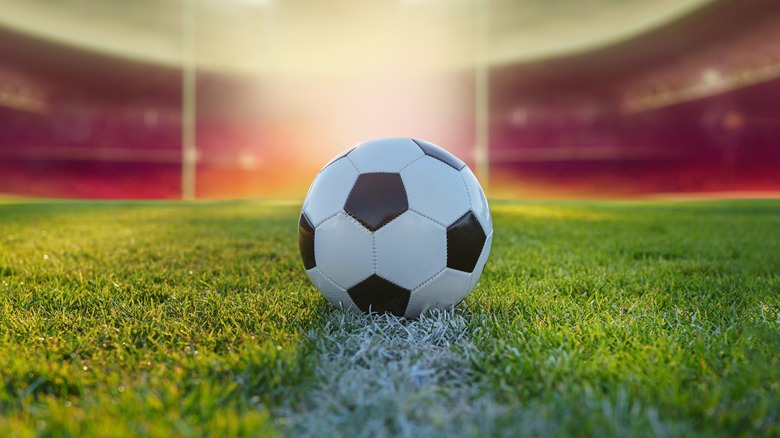 soccer ball on pitch empty stadium