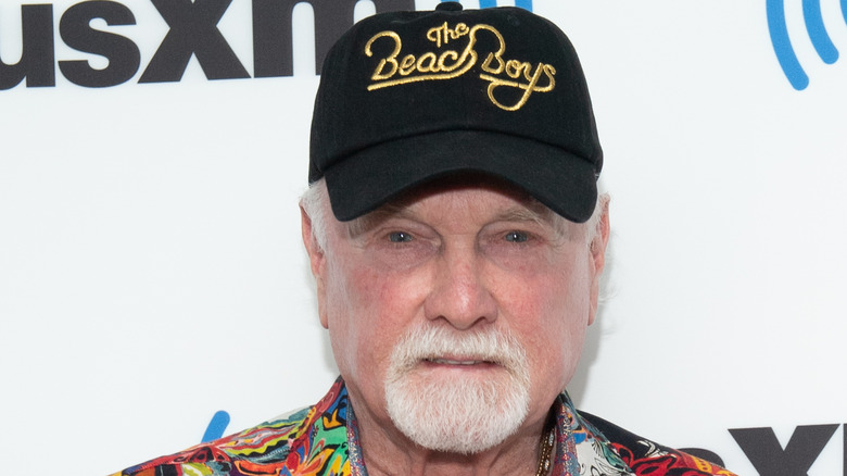 Mike Love grimacing on red carpet 