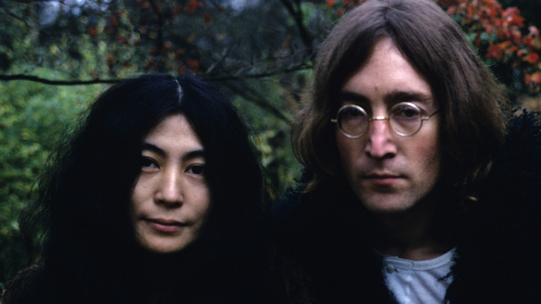 John Lennon and Yoko Ono posing