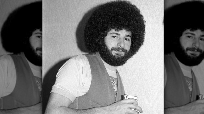 Sib Hashian afro smiling holding can