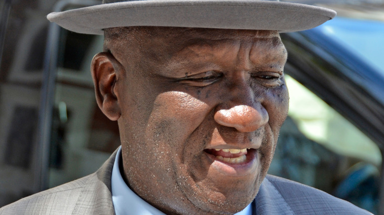 Bheki Cele in gray hat