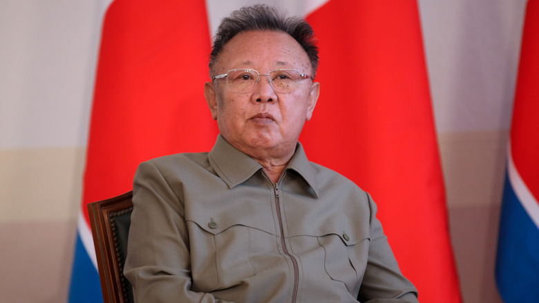 Kim Jong-Il in gray jacket sitting