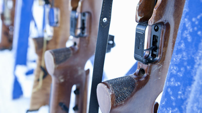 Close-up of triggers of rifles in a rack