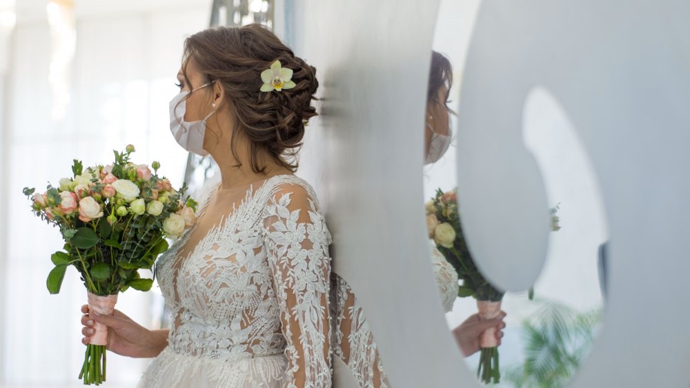 Bride with bouquet and mask