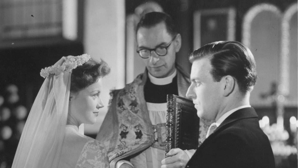 Priest marrying couple in 1950s