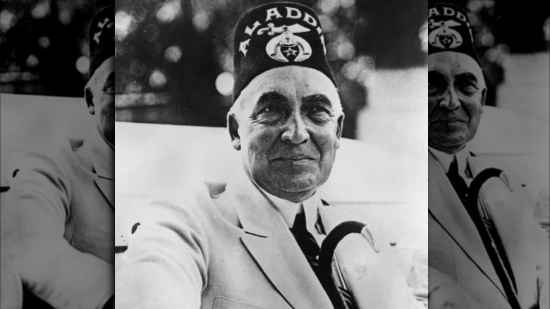 Warren G. Harding wearing a Shriner's hat