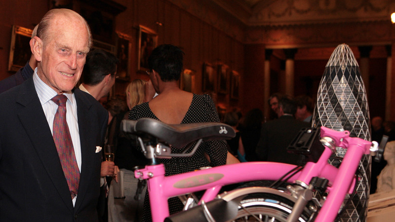 prince philip admiring a bike