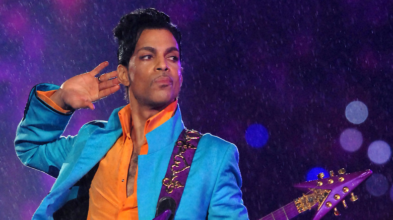 Prince onstage blue suit purple guitar