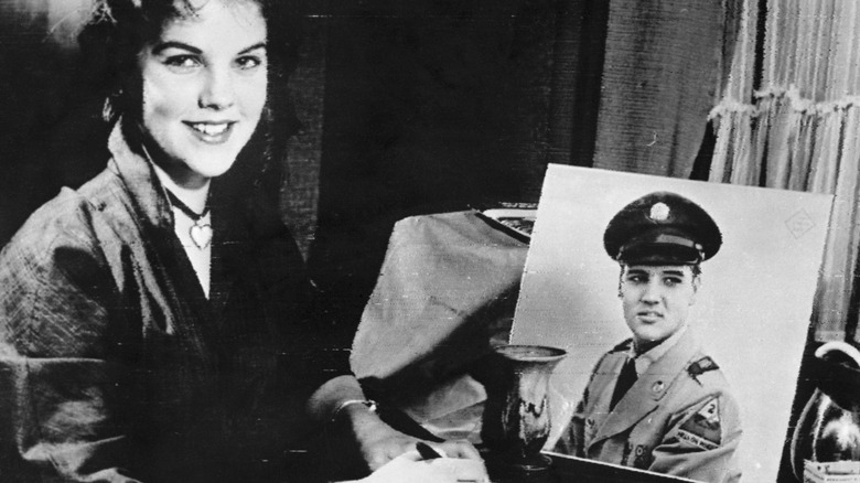 Priscilla Presley with a photo of Elvis