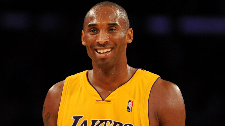 Kobe Bryant smiling in a Lakers jersey