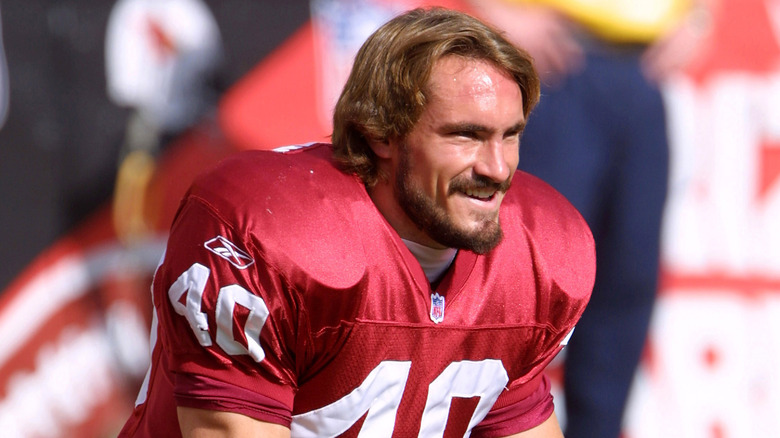 Pat Tillman smiling on the sideline in a Cardinals jersey