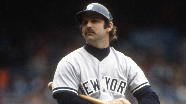 Thurman Munson holding a bat in a batting helmet