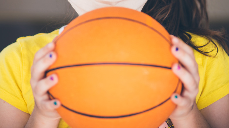 Woman holding basketball