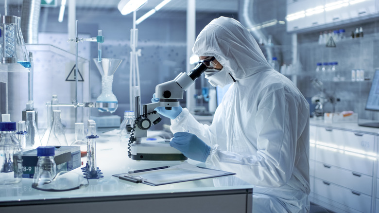 scientist in laboratory with microscope