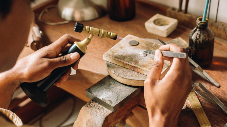 A jewelers hands welding jewelry