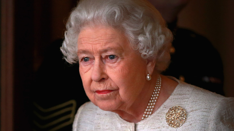 Queen Elizabeth wearing pearls and  gold broche