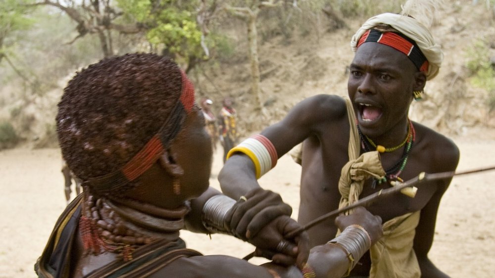  A woman of Ethiopia's Hamar Tribe struggles with a village chief