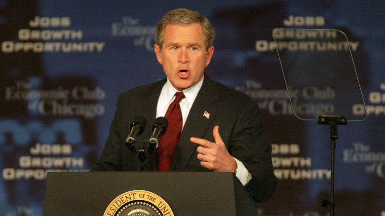 George W Bush at podium announce tax cuts