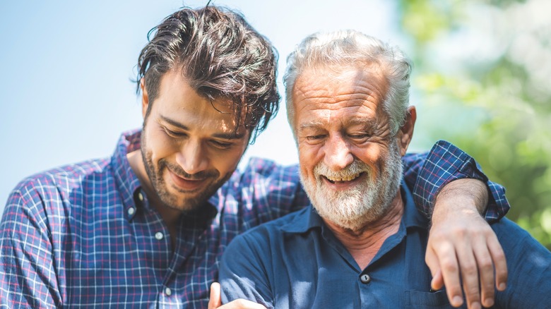 man and elderly man smiling