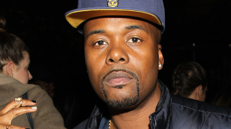 Memphis Bleek wearing blue hat