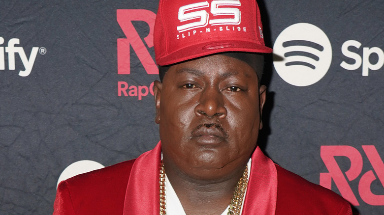 Trick Daddy wearing red hat